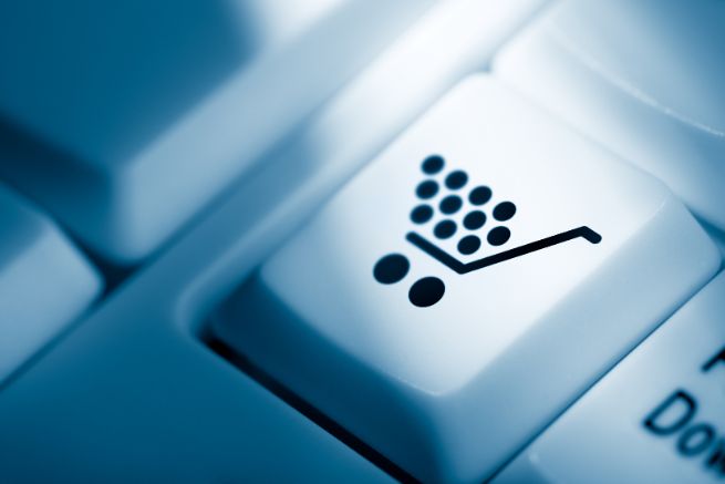 Computer keyboard concept image. Outright Buy button represented by a keyboard key with a shopping cart illustrated on it.