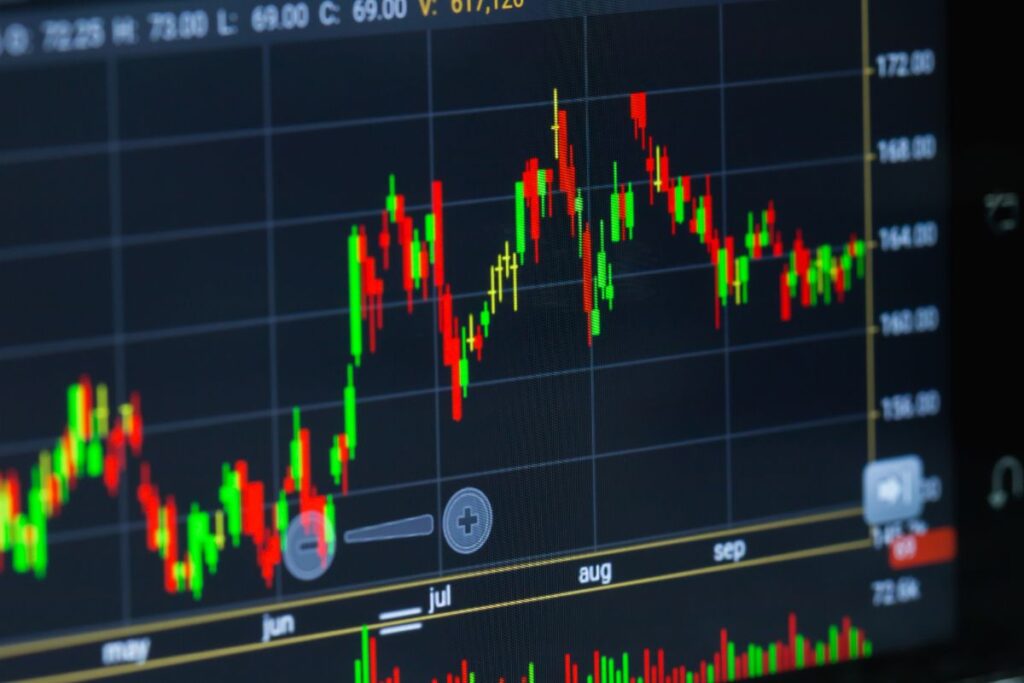Trading on a stock market with smartphone. Closeup photo.