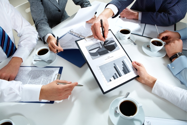 An image taked from above of hands business meeting related to excess electronic components.